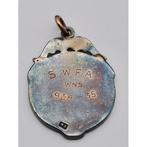 439 - A George V silver and enamel sporting fob medal, the front with a red enamelled lion rampant, hallma... 