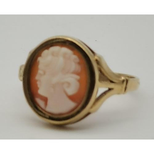 451 - A 9 carat gold cameo ring, the oval cameo of a female facing left, the gold mount set to pierced sho... 