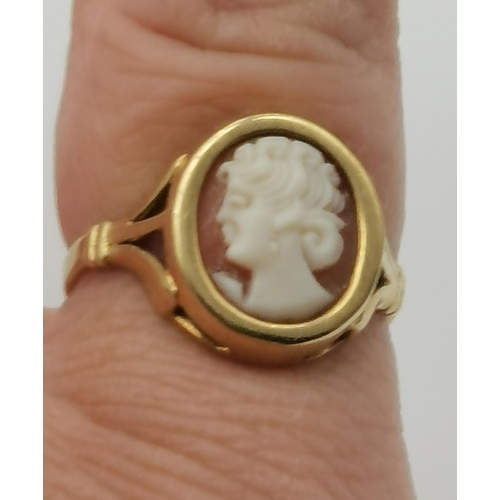 451 - A 9 carat gold cameo ring, the oval cameo of a female facing left, the gold mount set to pierced sho... 