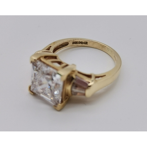 456 - A 14 carat gold white stone ring, the central square-cut cubic zirconia flanked by three baguette-cu... 