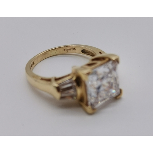 456 - A 14 carat gold white stone ring, the central square-cut cubic zirconia flanked by three baguette-cu... 