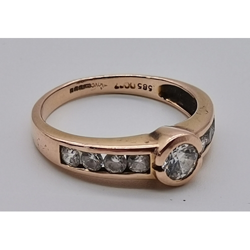 459 - A 14 carat rose gold nine stone ring, the central circular cubic zirconia flanked by four smaller ci... 