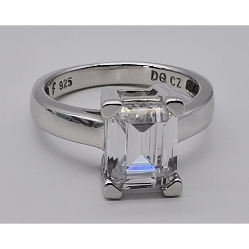 461 - A silver three stone ring, set with a trio of graduated circular cubic zirconias, stamped 925 and CZ... 