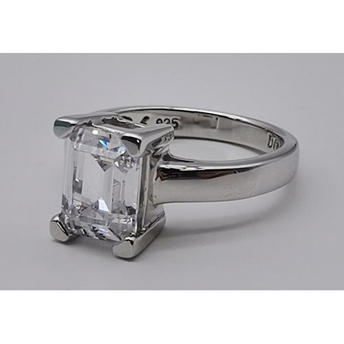 461 - A silver three stone ring, set with a trio of graduated circular cubic zirconias, stamped 925 and CZ... 