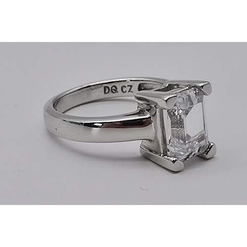 461 - A silver three stone ring, set with a trio of graduated circular cubic zirconias, stamped 925 and CZ... 