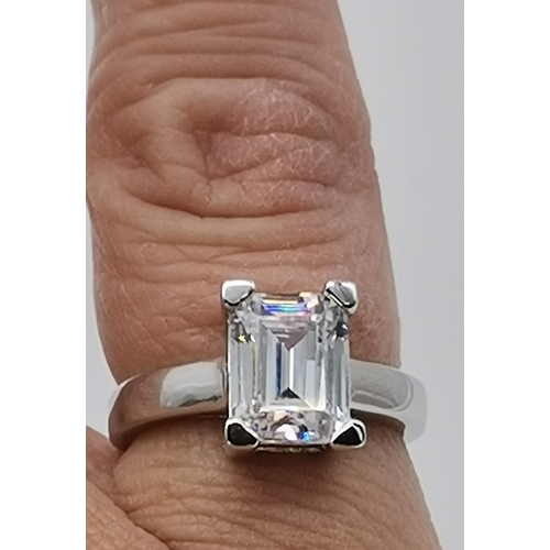 461 - A silver three stone ring, set with a trio of graduated circular cubic zirconias, stamped 925 and CZ... 