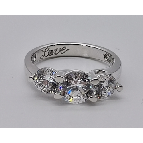 461 - A silver three stone ring, set with a trio of graduated circular cubic zirconias, stamped 925 and CZ... 