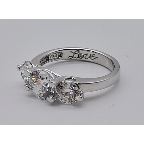 461 - A silver three stone ring, set with a trio of graduated circular cubic zirconias, stamped 925 and CZ... 