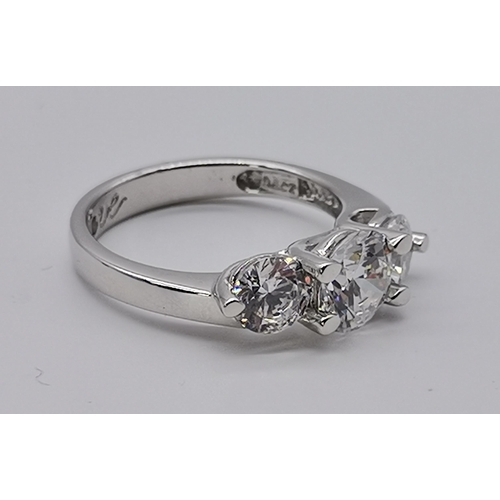 461 - A silver three stone ring, set with a trio of graduated circular cubic zirconias, stamped 925 and CZ... 