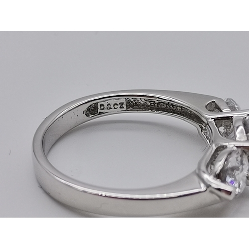 461 - A silver three stone ring, set with a trio of graduated circular cubic zirconias, stamped 925 and CZ... 