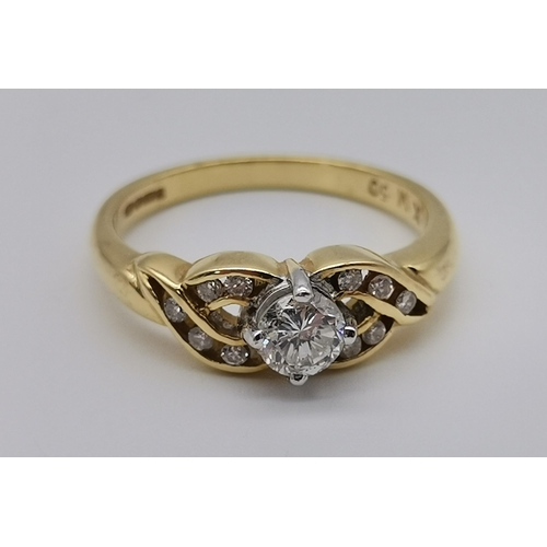 470 - An 18 carat gold diamond ring, 21st Century, the principle round stone claw-set to openwork cross-ov... 