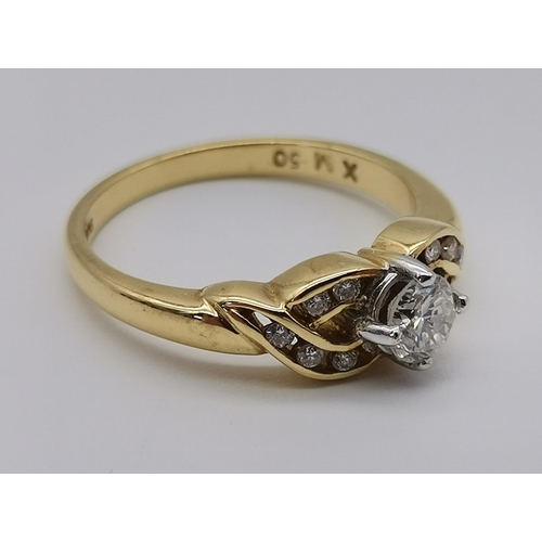 470 - An 18 carat gold diamond ring, 21st Century, the principle round stone claw-set to openwork cross-ov... 