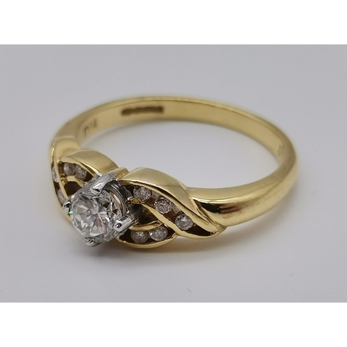 470 - An 18 carat gold diamond ring, 21st Century, the principle round stone claw-set to openwork cross-ov... 