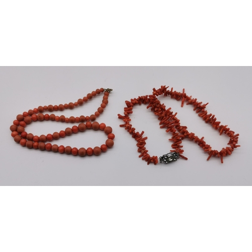 493 - A coral necklace, a coral and plastic bead necklace, and a faceted bead and carved wood necklace. (3... 