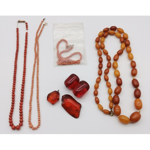 494 - An amber-type necklace of graduated oval cloudy beads; two loose amber-type pieces and another two c... 