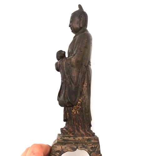 537 - A Chinese bronze figural statue, likely Ming dynasty, made using the lost wax method, with gilt and ... 