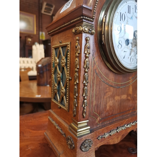 708 - Oak cased mantle clock with brass detailing with key and pendulum