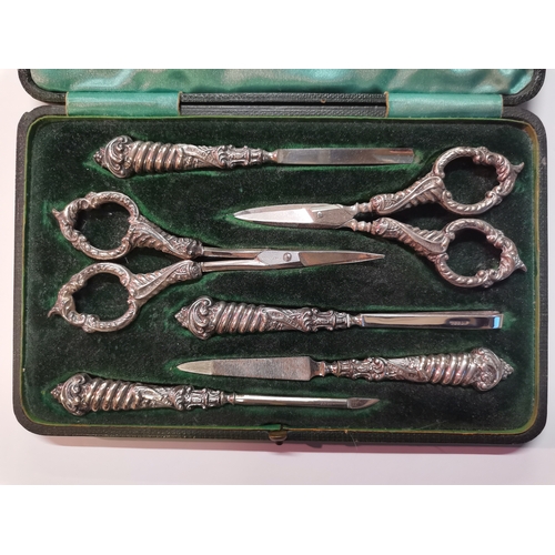 388 - A Edwardian silver-handled six piece manicure set by Edward Souter Barnsley, Birmingham 1901, in fit... 