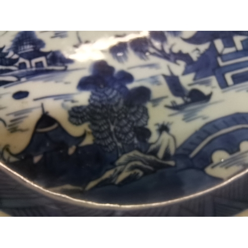 54 - A small collection of assorted blue and white ceramic wares comprising a Delft charger; an oval dish... 