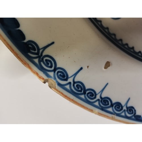 54 - A small collection of assorted blue and white ceramic wares comprising a Delft charger; an oval dish... 