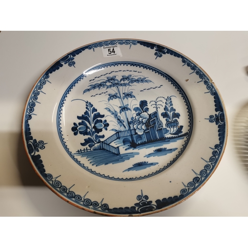 54 - A small collection of assorted blue and white ceramic wares comprising a Delft charger; an oval dish... 