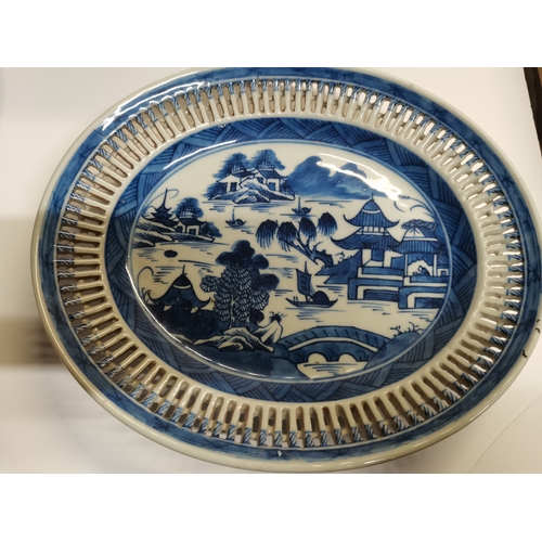 54 - A small collection of assorted blue and white ceramic wares comprising a Delft charger; an oval dish... 