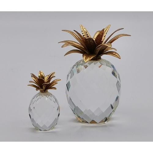 102 - A Collection Of Swarovski Crystal including large and small Pineapple with gold leaves, A large and ... 