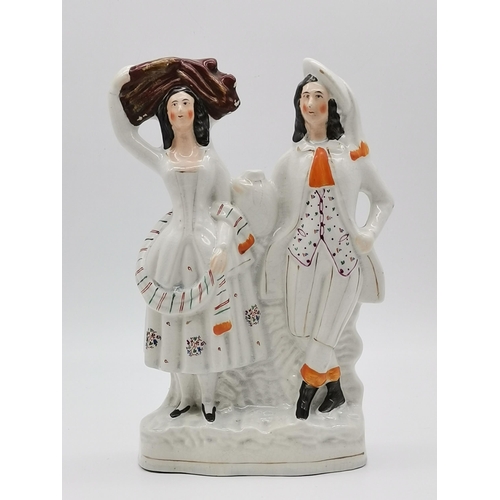 11 - A Staffordshire flat-back figure group, Harvest Couple; together with a Staffordshire spill vase fig... 