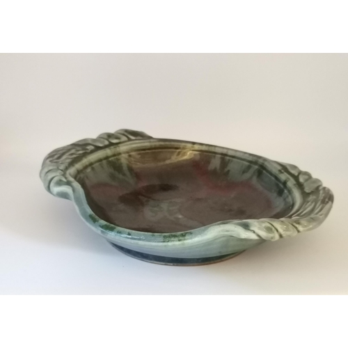 116 - Four pieces of studio pottery, comprising a square pedestal dish by Jackie Walton; a shallow twin-ha... 