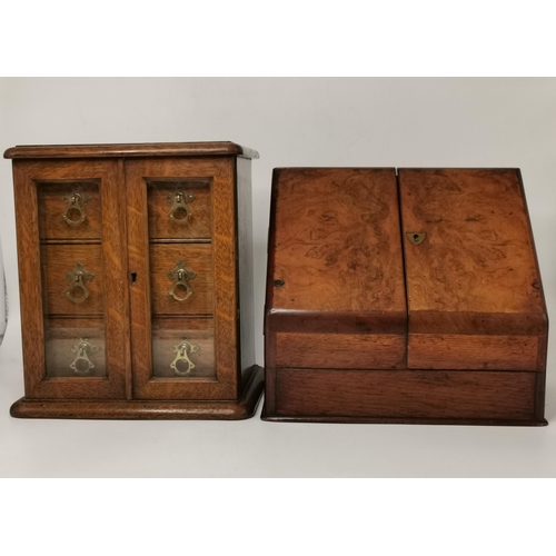 141 - A small oak tabletop cabinet, the pair of glazed doors opening to reveal three drawers with brass ha... 