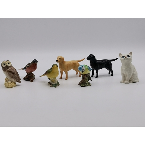 146 - A collection of Beswick animals including black and golden Labrador, White cat, Owl etc (7)