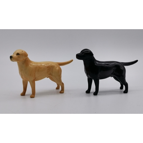 146 - A collection of Beswick animals including black and golden Labrador, White cat, Owl etc (7)