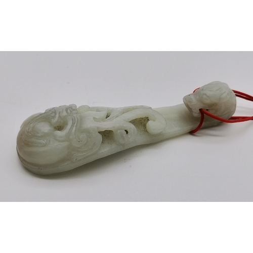 177 - A Chinese hetian jade belt hook, Qing dynasty, carved with a dragon head and openwork chilong. 10.7c... 