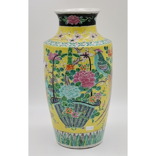 179 - A Chinese porcelain vase 19th century in a brilliant and vibrant yellow back ground and having peaco... 