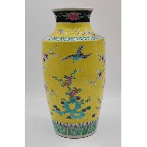 179 - A Chinese porcelain vase 19th century in a brilliant and vibrant yellow back ground and having peaco... 