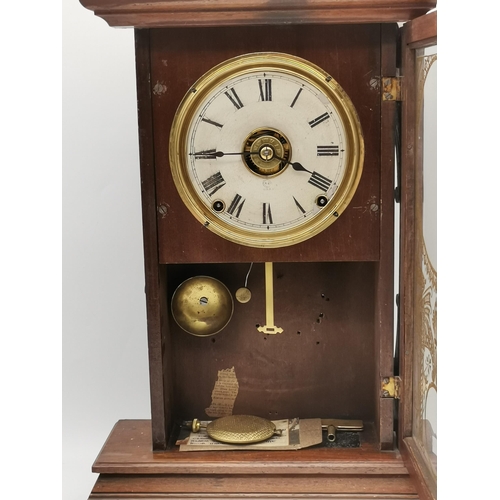 20 - An American wooden cased railway clock, 19th Century, the cream circular dial with black Roman numer... 