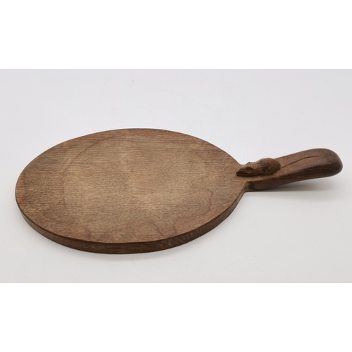 204 - Robert Thompson, a Mouseman oak cheese board, oval, with carved mouse signature to handle. 37cm long... 