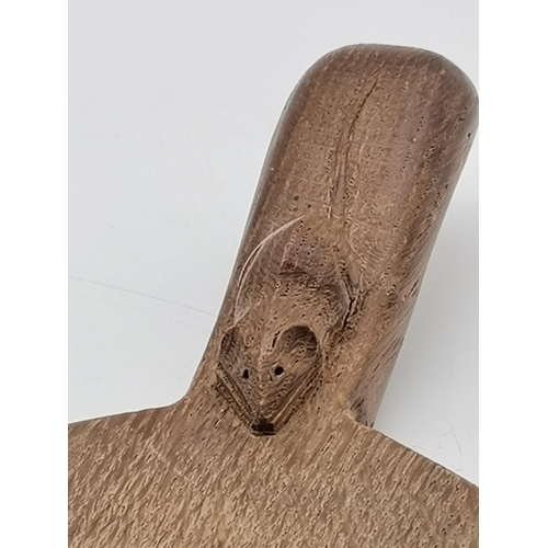 204 - Robert Thompson, a Mouseman oak cheese board, oval, with carved mouse signature to handle. 37cm long... 