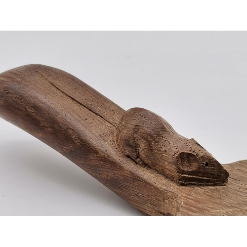 204 - Robert Thompson, a Mouseman oak cheese board, oval, with carved mouse signature to handle. 37cm long... 