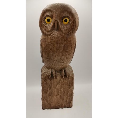 205 - A carved oak owl, standing on a tooled square base, with dark fumed feather detail, painted yellow a... 