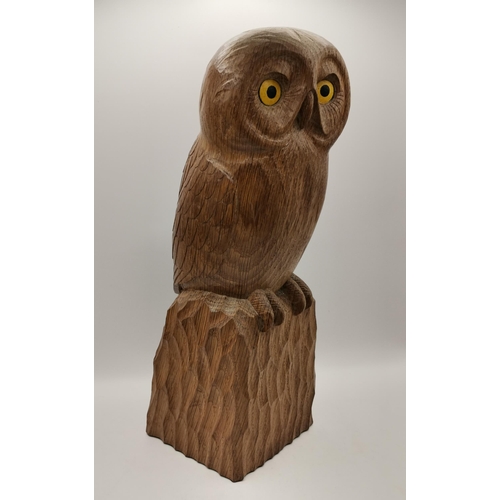 205 - A carved oak owl, standing on a tooled square base, with dark fumed feather detail, painted yellow a... 