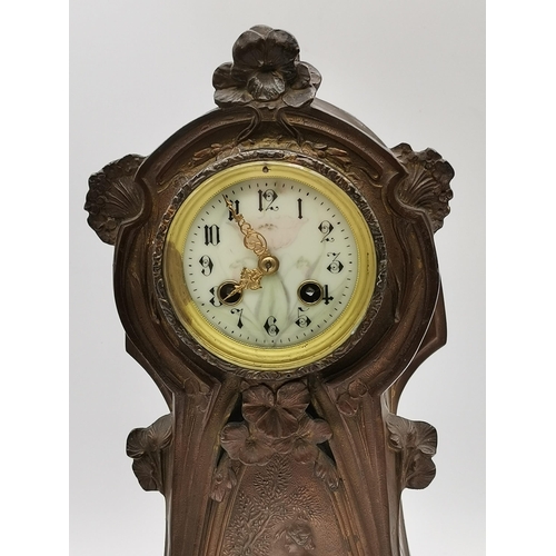 24 - An Art Nouveau three-piece clock garniture, 20th Century, copper patinated spelter, the cream circul... 