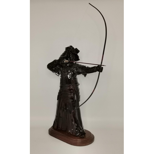 36 - Glazed figure of Warrior with bow and arrow on wooden stand figure 46cm height