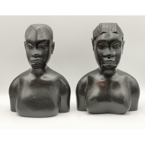 49 - A collection of African wooden carvings, comprising a male and female bust, three figures in a canoe... 