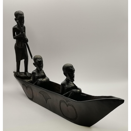 49 - A collection of African wooden carvings, comprising a male and female bust, three figures in a canoe... 