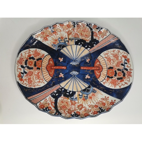 60 - A selection of Imari pattern wares, including a lobed oval platter, two scalloped small chargers; to... 