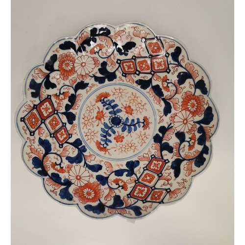 60 - A selection of Imari pattern wares, including a lobed oval platter, two scalloped small chargers; to... 