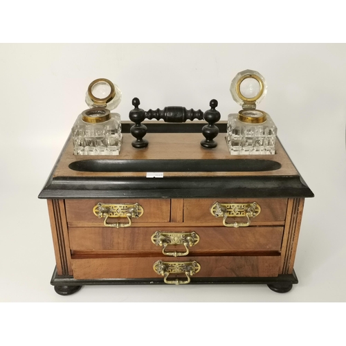 65 - A Victorian walnut desk standish and stationery cabinet, the top with two pen trays, a pair of squar... 