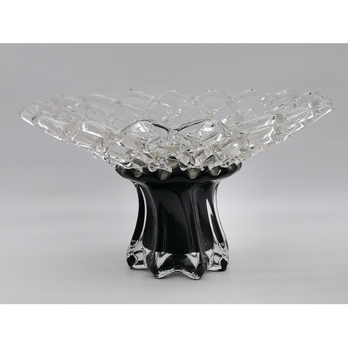 74 - A large contemporary black and clear glass pedestal centrepiece and vase, each with modernist openwo... 