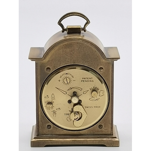 78 - A miniature brass cased alarm clock by Swiza, with engraved gilt metal face, the brushed steel chapt... 